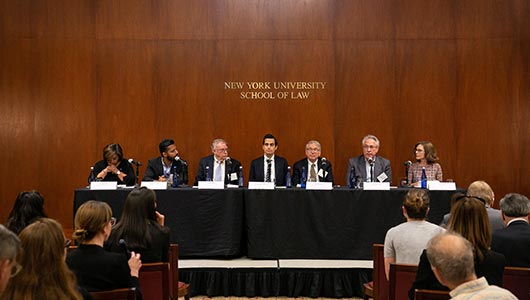 Photograph of panel of people at the NYU School of Law