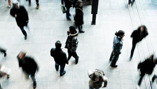 Photograph of blurred people walking, from above